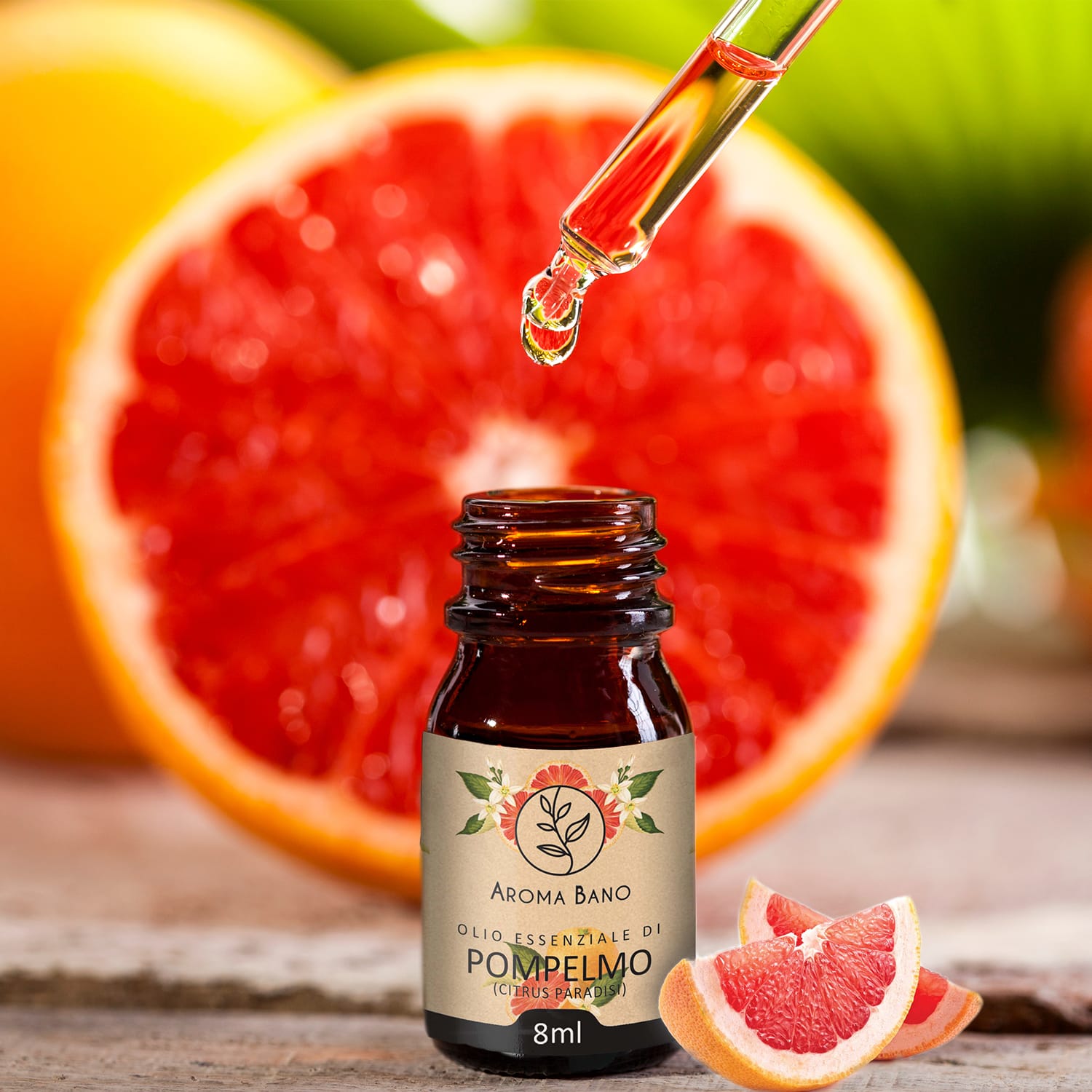 Gocce di olio essenziale di Pompelmo Aroma Bano da 8 ml applicate vicino a pompelmo fresco tagliato