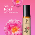 Olio essenziale di rosa damascena Aroma Bano in roll on con fiore di rosa su sfondo rosa