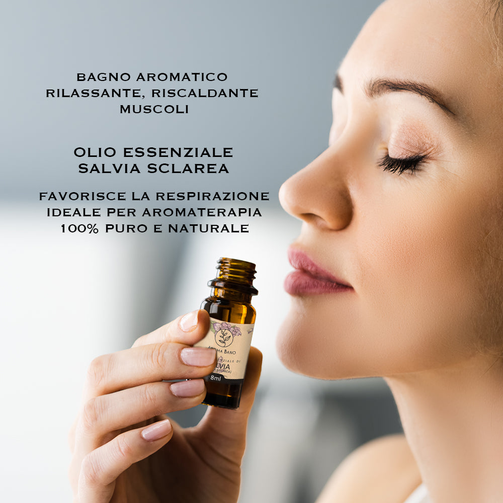 Persona che utilizza l’olio essenziale di salvia sclarea Aroma Bano da 8 ml avvicinando la bottiglia al viso per un momento di aromaterapia