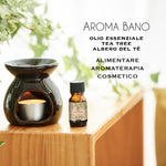 Olio essenziale di Tea Tree utilizzato in aromaterapia con bruciatore e candela